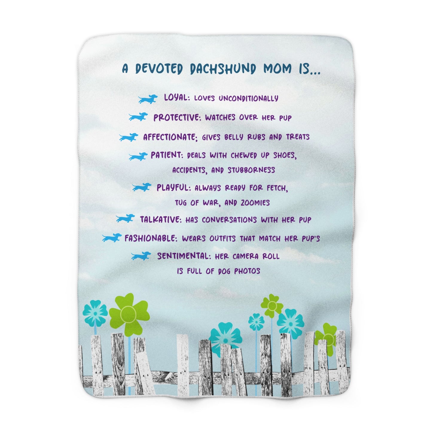A blanket with text that lists qualities of a devoted dachshund mom, decorated with illustrations of dachshunds, flowers, and a fence.