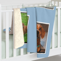 Blue blanket with dog prints hanging on a white rack.